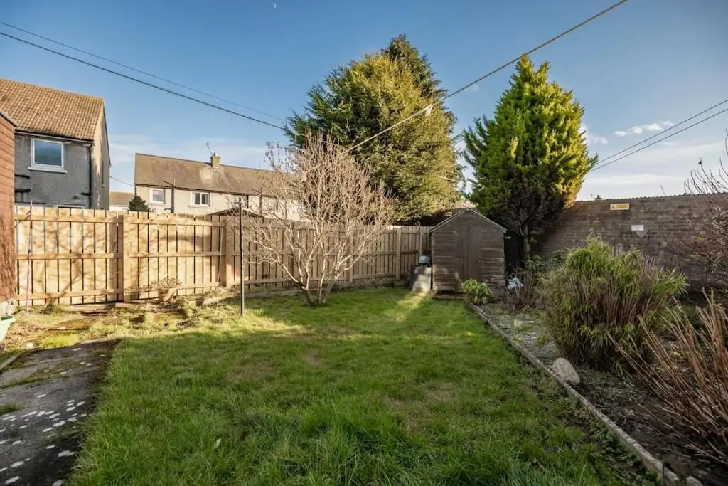 a backyard with a wooden fence and a yard at Aberdeen Home near City in Aberdeen