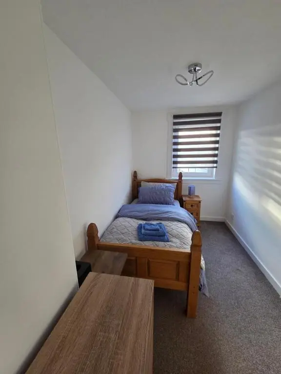 a small bedroom with a bed and a window at Evan Barron Apartment, Inverness in Inverness