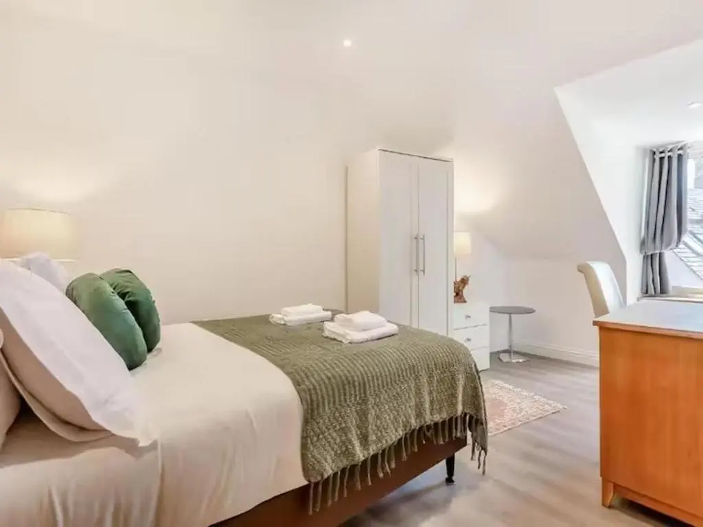 a white bedroom with a bed and a dresser at Family - Central - Wifi - Parking - Sleeps 4 in Inverness