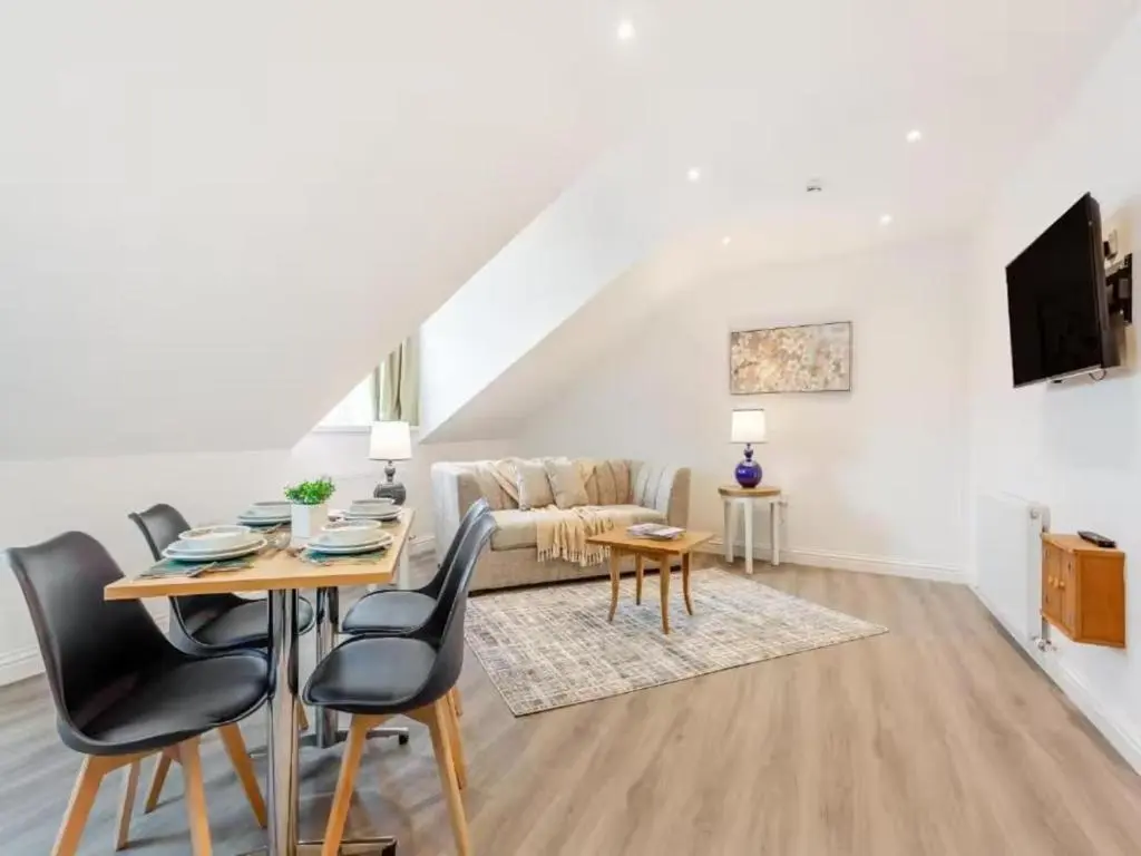 a living room with a table and chairs and a couch at Family - Central - Wifi - Parking - Sleeps 4 in Inverness