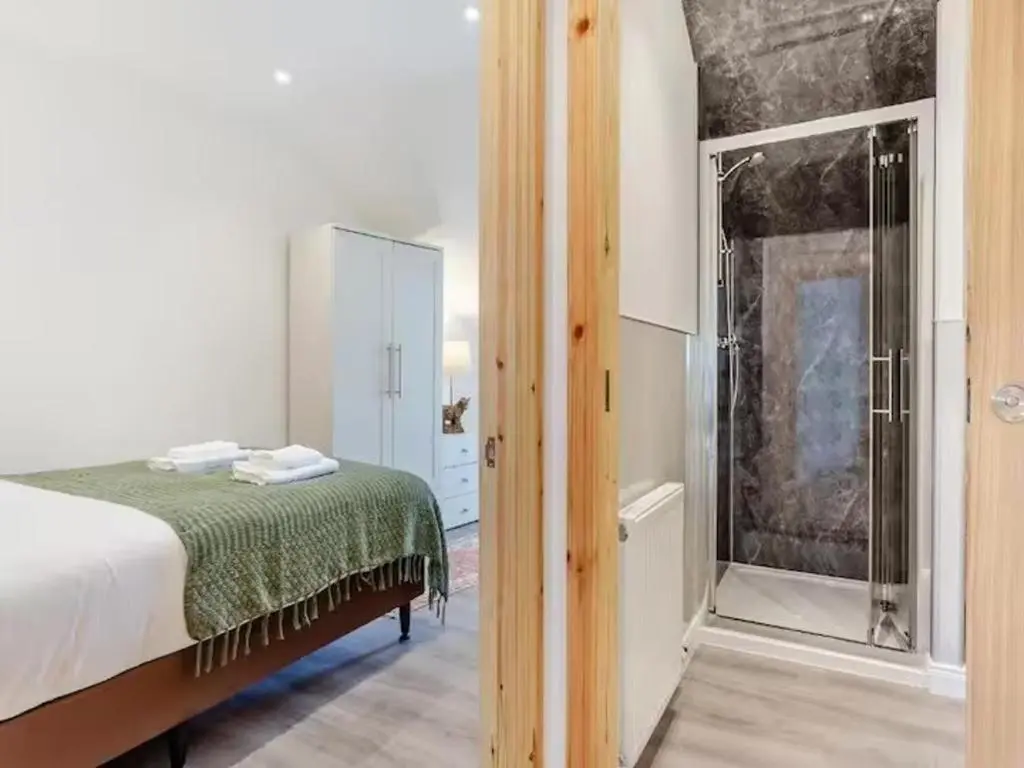 a bedroom with a bed and a glass door at Family - Central - Wifi - Parking - Sleeps 4 in Inverness