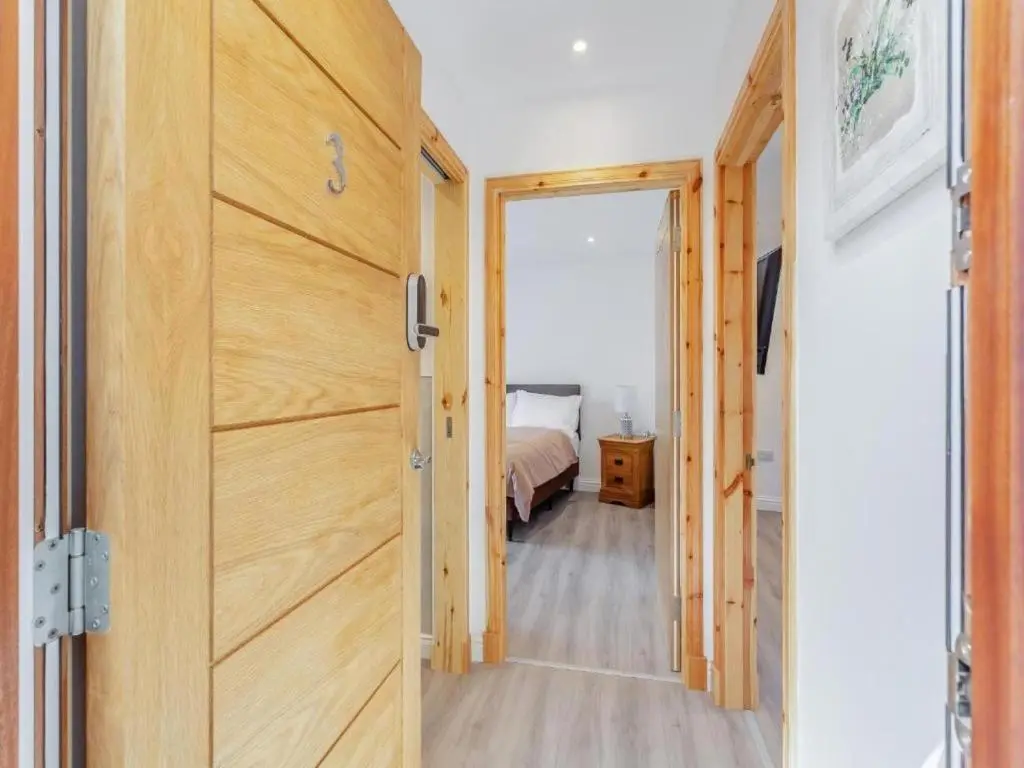 a door leading to a bedroom with a bed at Family - Central - Parking - Wifi - Sleeps 3 in Inverness