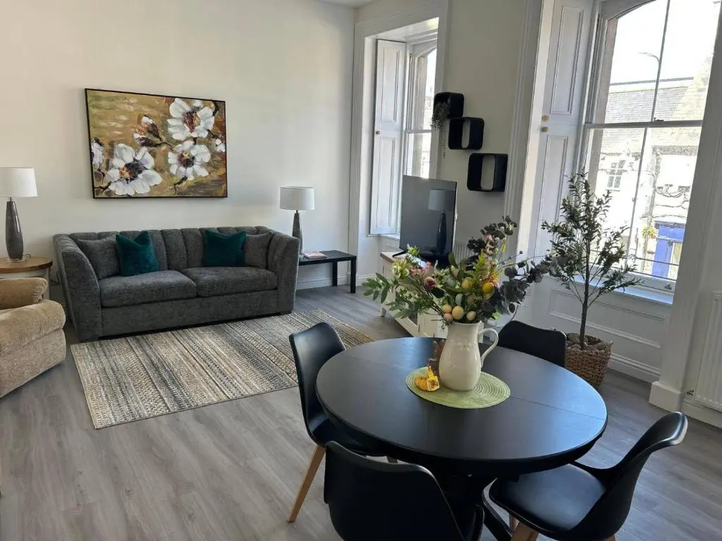 a living room with a table and a couch at Family - Parking - Central - Wifi - Sleeps 4 in Inverness