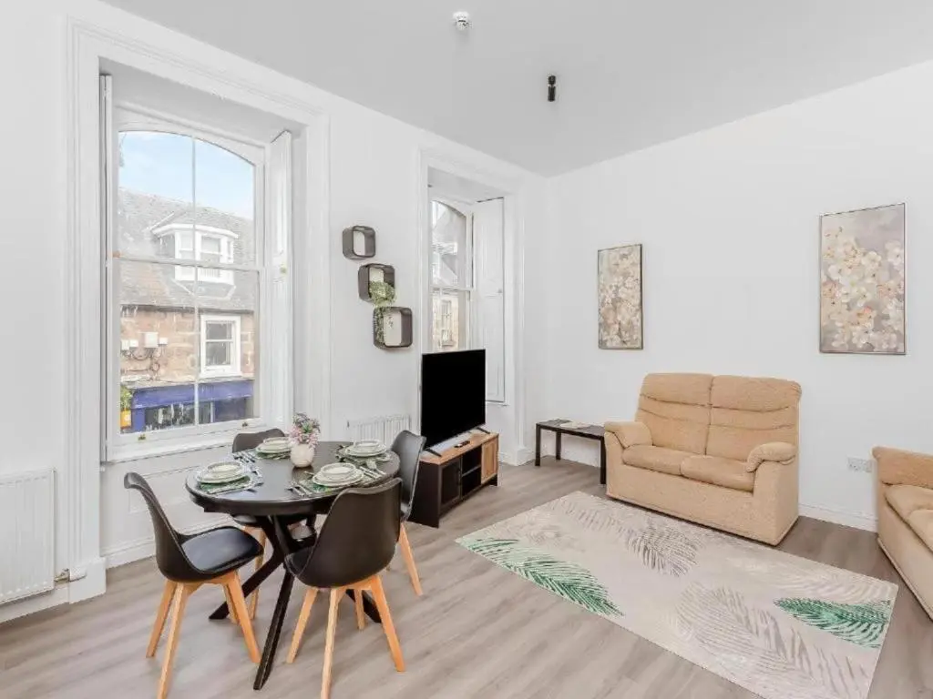 a living room with a table and a couch at Family - Central - Parking - Wifi - Sleeps 4 in Inverness