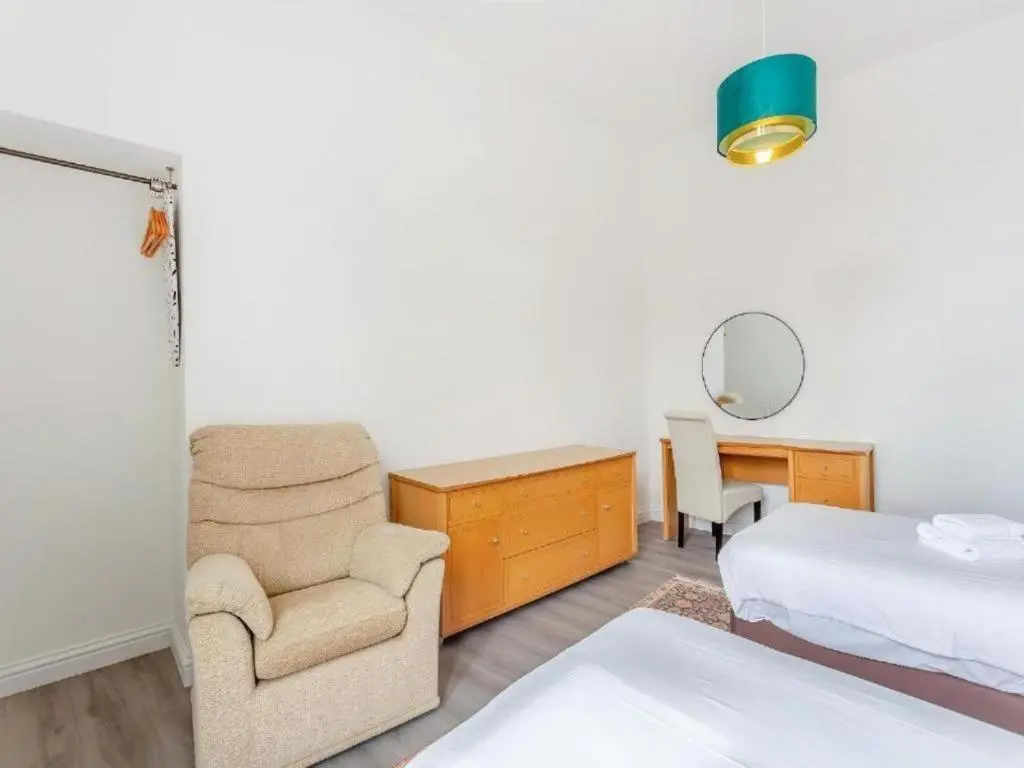 a bedroom with a bed and a chair and a desk at Family - Central - Parking - Wifi - Sleeps 4 in Inverness
