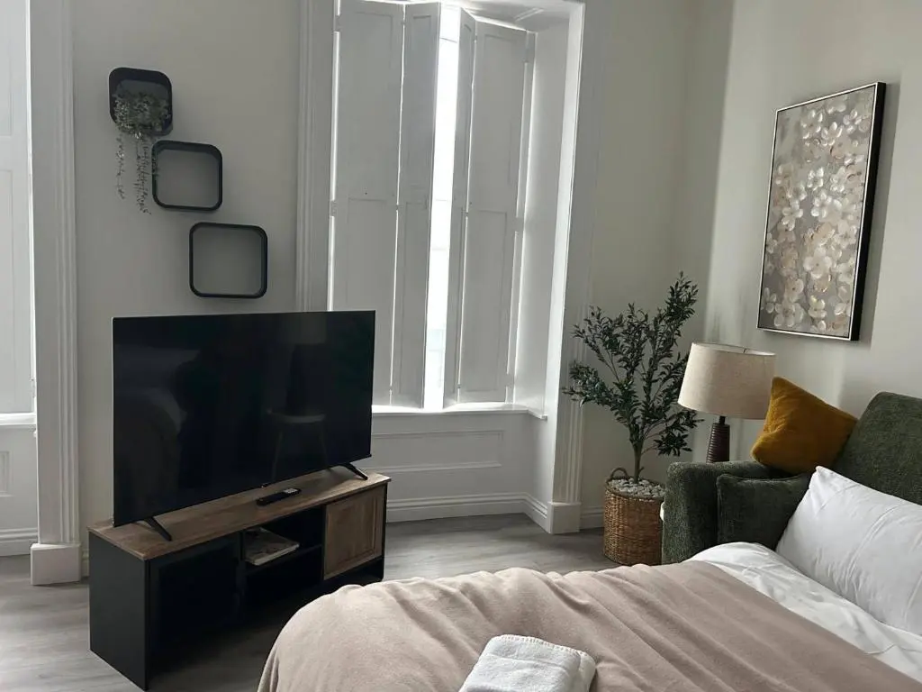 a living room with a flat screen tv and a couch at Family - Central - Parking - Wifi - Sleeps 4 in Inverness