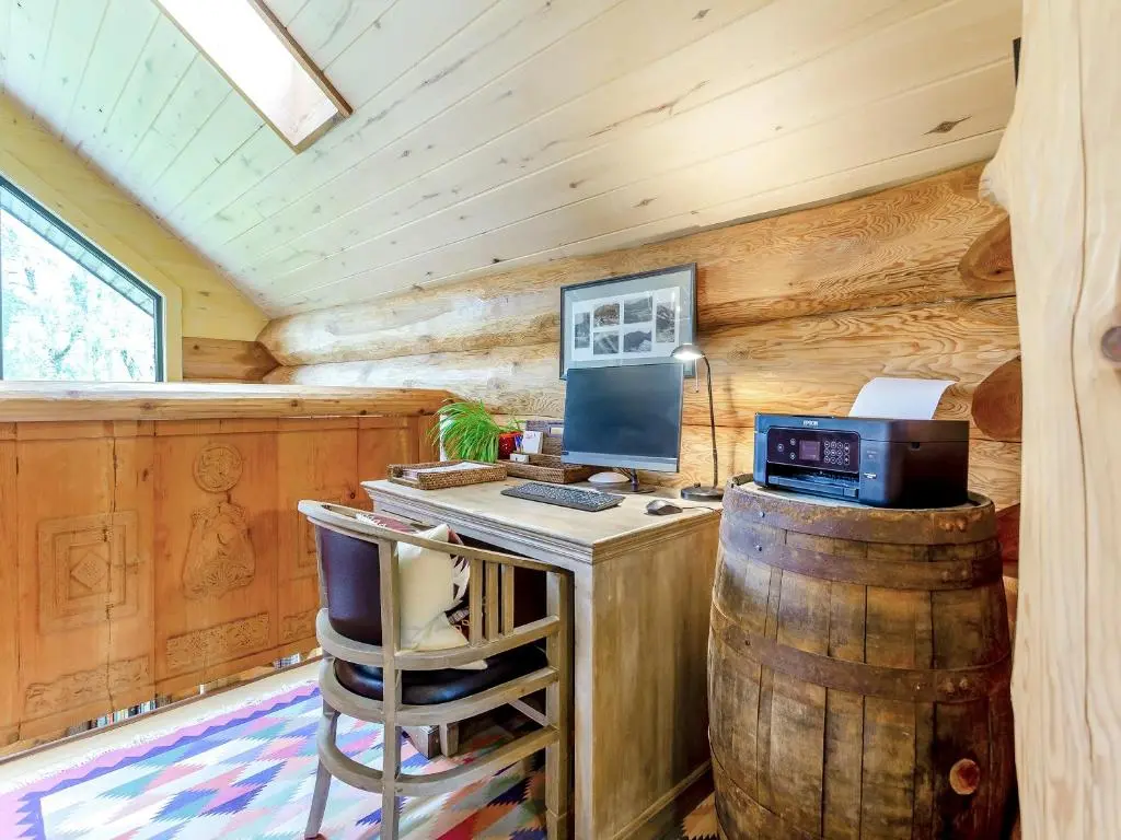 a desk with a computer in a room with wooden walls at Strix - Uk50082 in Struy