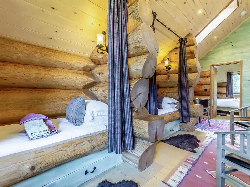 a room with two beds in a log cabin at Buteo - Uk50068 in Struy