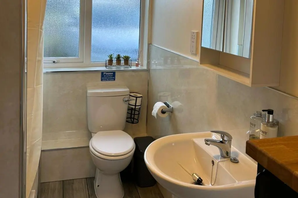 a bathroom with a toilet and a sink at Hot tub - Garden - Bbq - Parking - Pets - Sleeps 6 in Strathpeffer