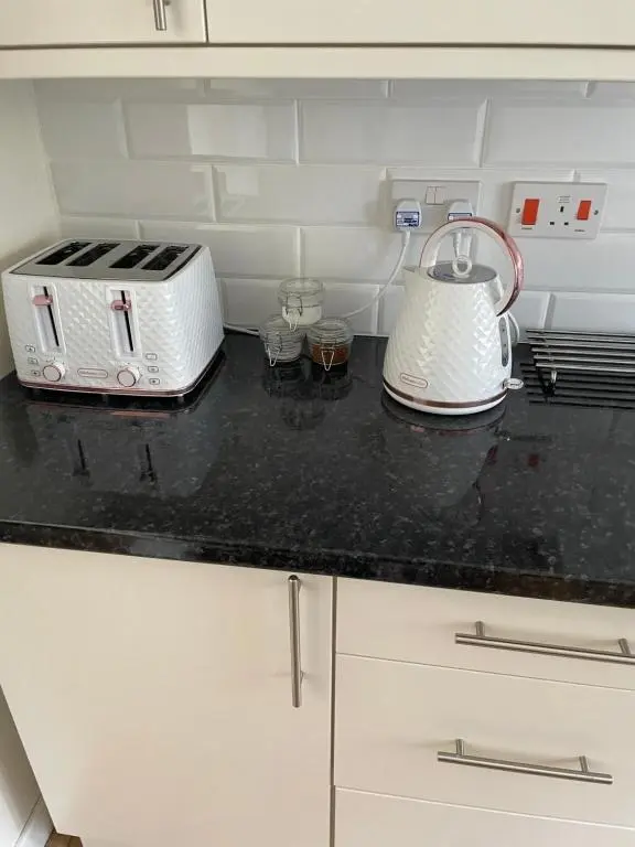 a kitchen counter with a toaster and a toaster at Millburn Court Apartment in Inverness