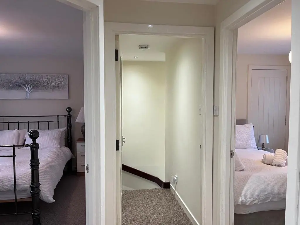 a room with a bedroom with a bed and a mirror at Millburn Court Apartment in Inverness