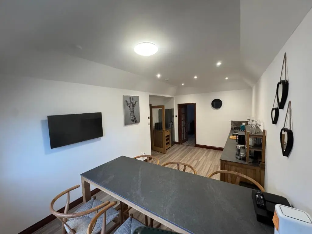 a living room with a table and chairs at TSB Accommodation in Turriff