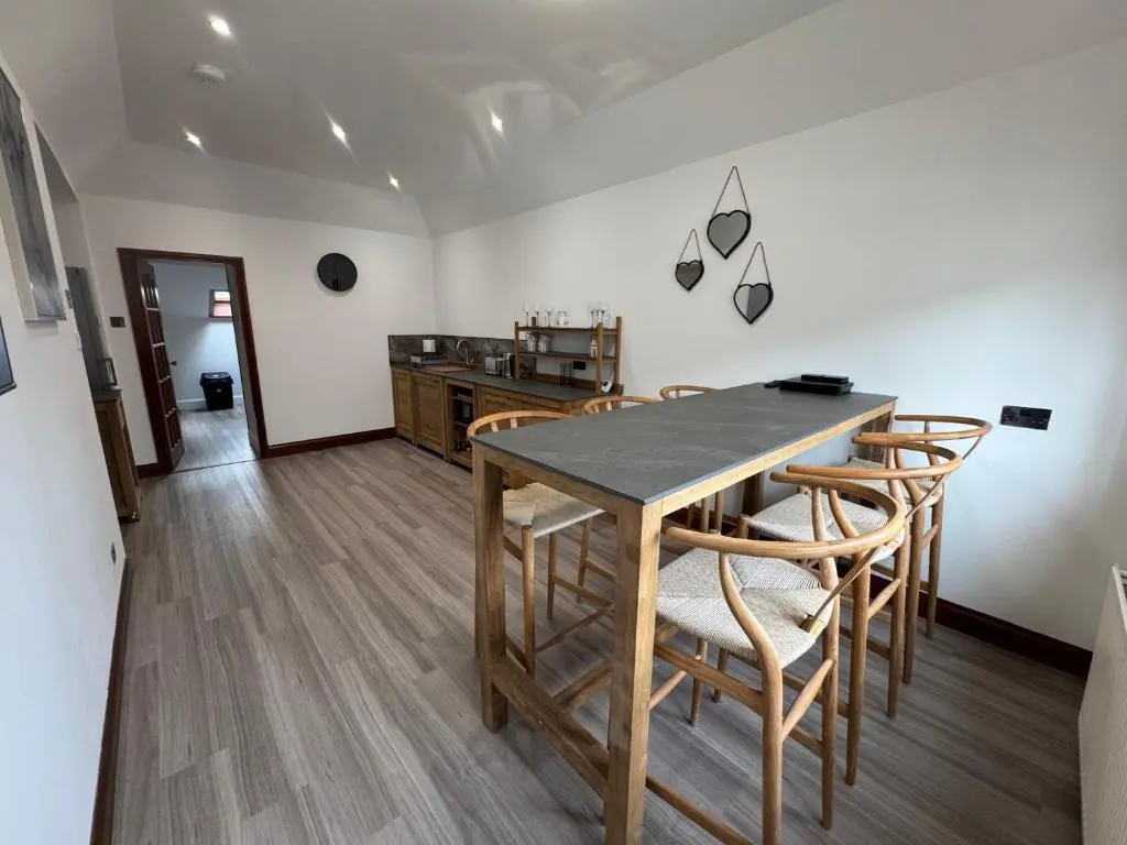 a kitchen and dining room with a table and chairs at TSB Accommodation in Turriff
