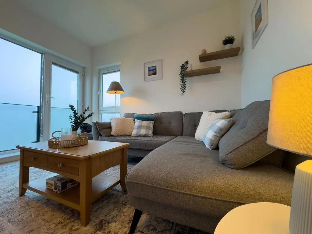 a living room with a couch and a table at Beinn View in Inverness