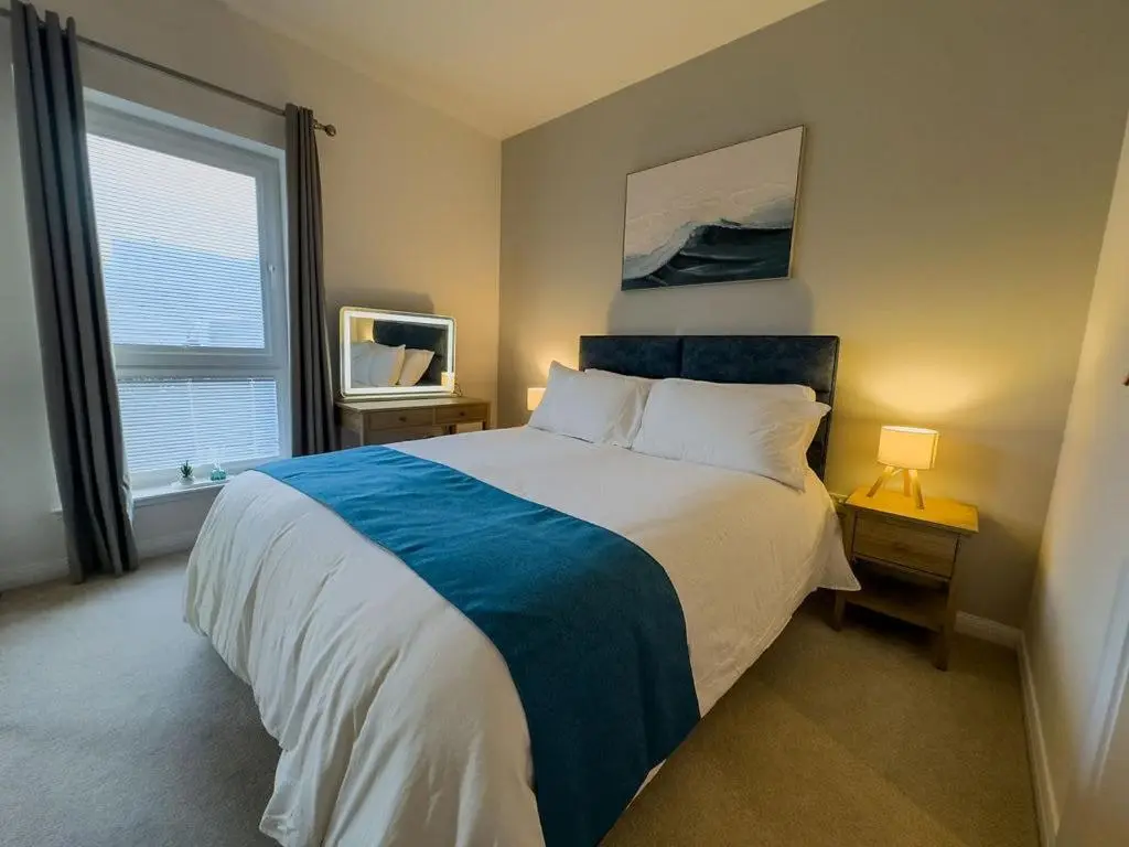 a bedroom with a large bed and a window at Beinn View in Inverness