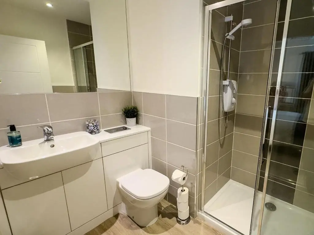a bathroom with a toilet and a sink and a shower at Beinn View in Inverness