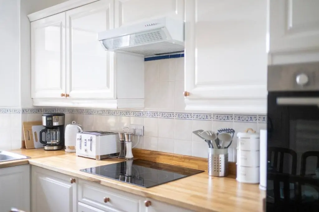 a kitchen with white cabinets and a counter top at Century House - 4BR - Free Parking - City Centre in Inverness