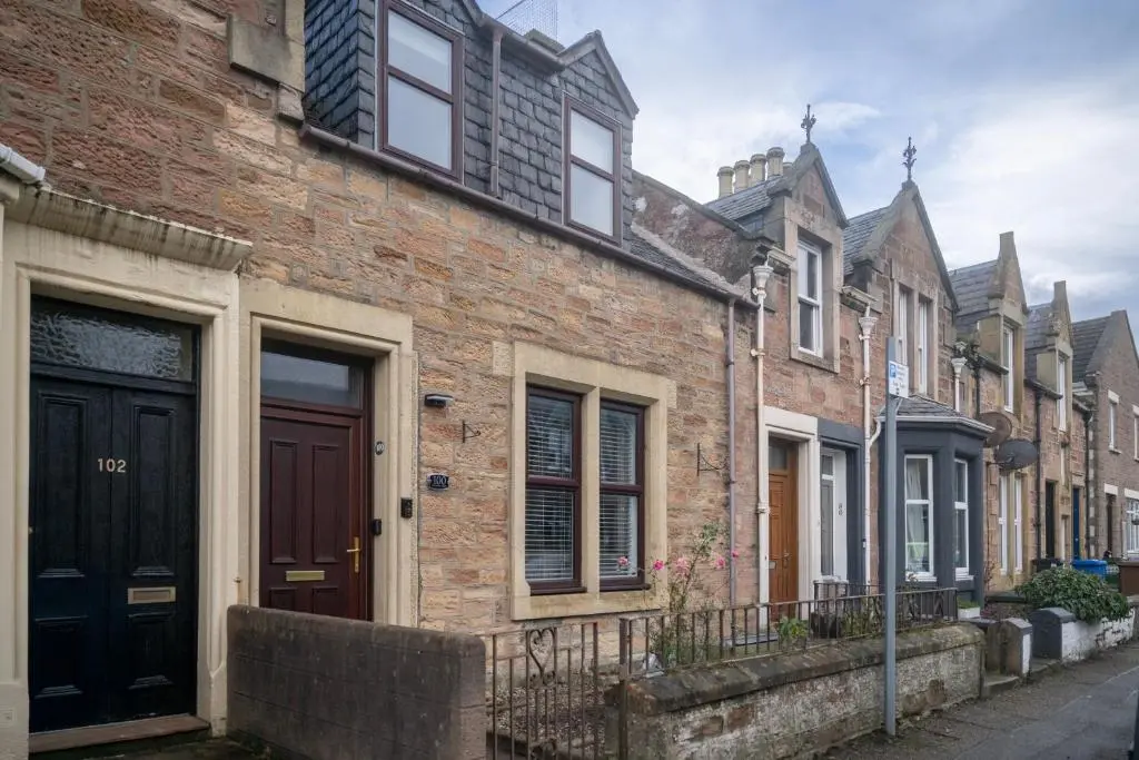 a row of brick houses on a street at Century House - 4BR - Free Parking - City Centre in Inverness