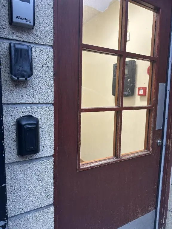 a door with a window next to a building at LaScala Apartment in Inverness