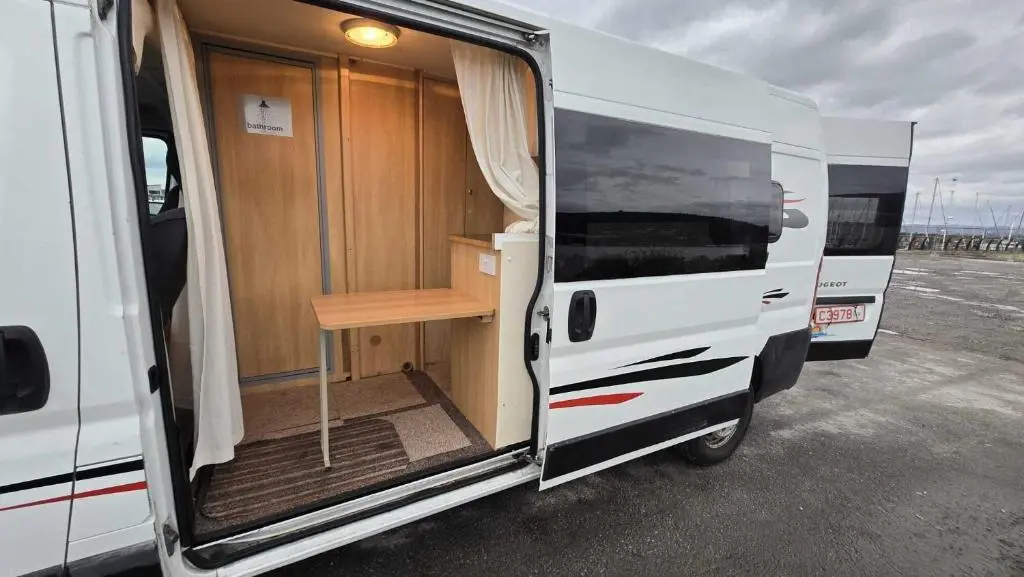an open door of an rv with a table inside at Rover Rentals in Inverness
