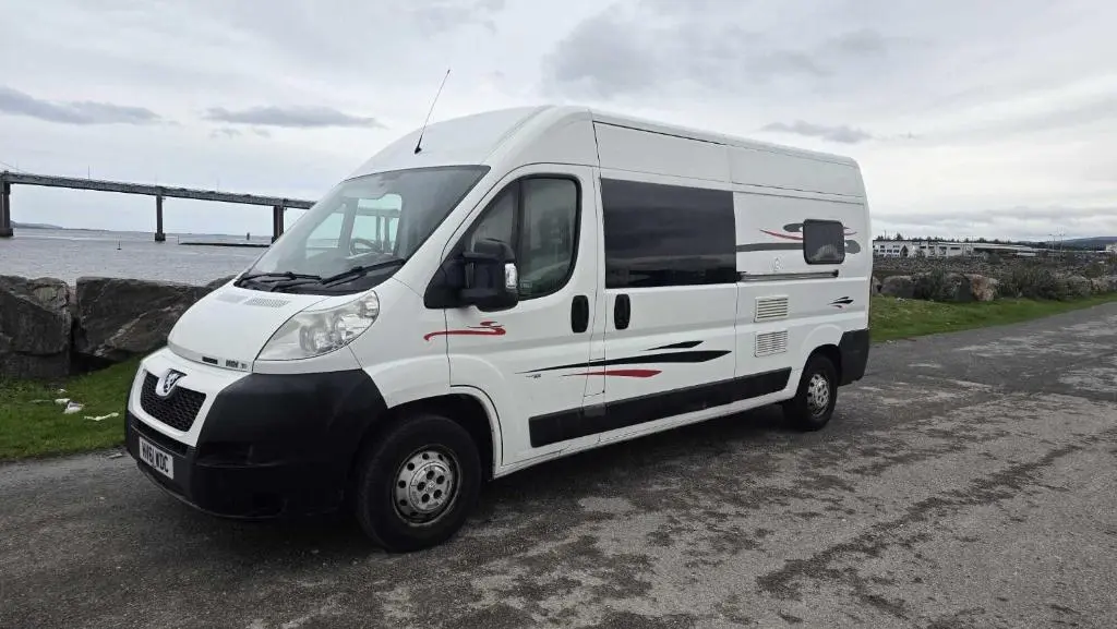 a white van parked on the side of a road at Rover Rentals in Inverness