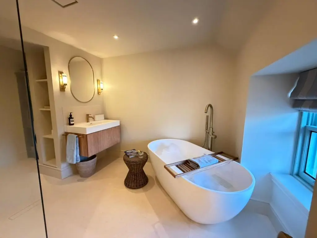 a bathroom with a large tub and a sink at Gilchrist Square in Dornoch