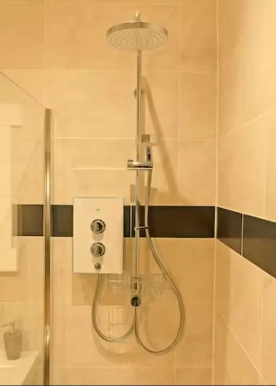 a shower with a shower head in a bathroom at Cateran Rest in Kirkmichael