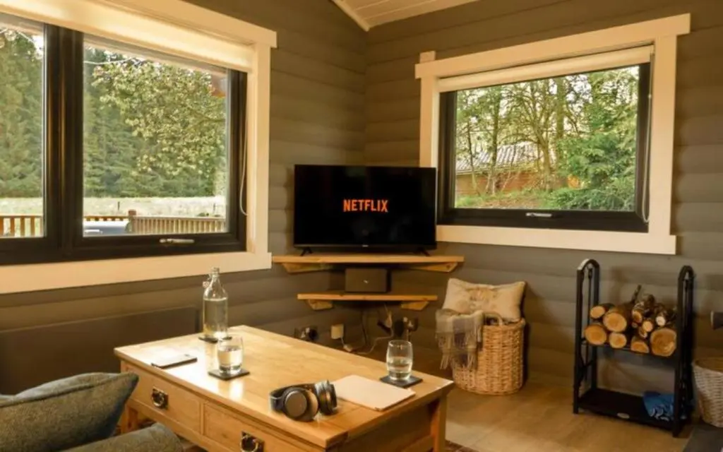 a living room with two windows and a tv at Cateran Rest in Kirkmichael
