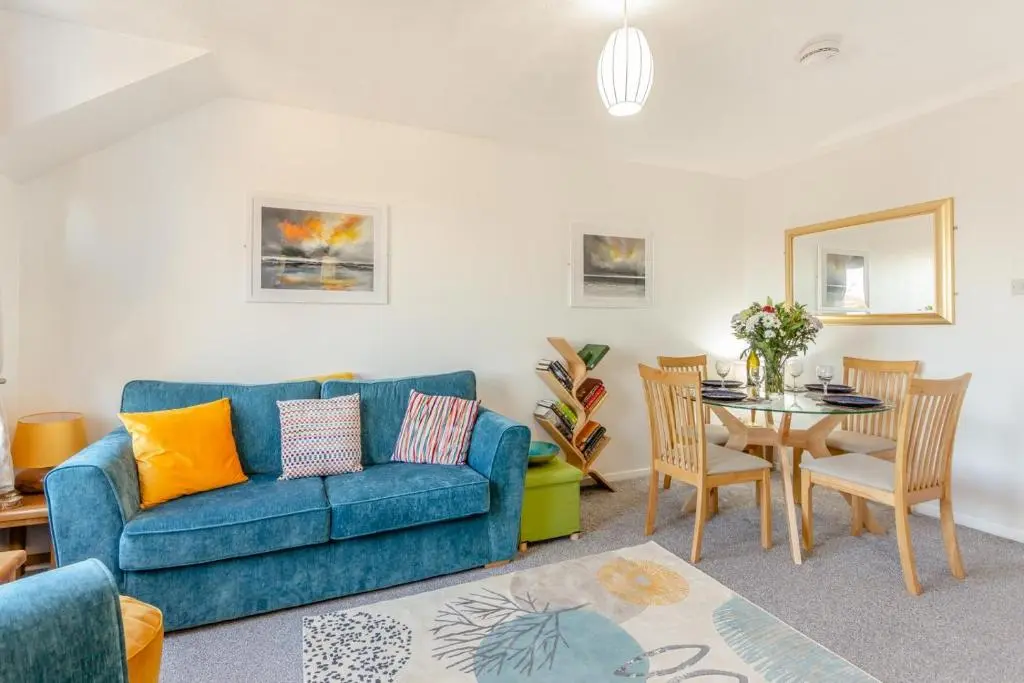 a living room with a blue couch and a table at 2 Bed in Nairn oc-t34496 in Nairn
