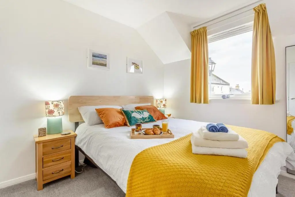 a bedroom with a bed with a yellow blanket at 2 Bed in Nairn oc-t34496 in Nairn