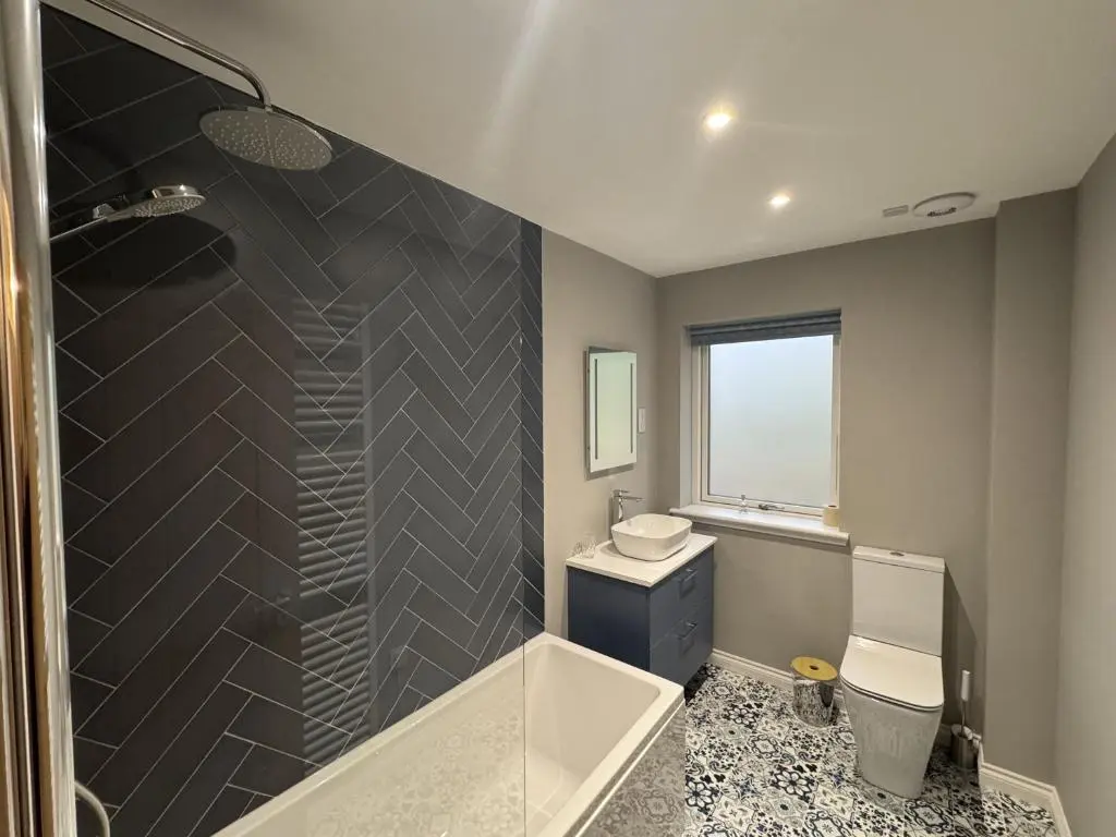 a bathroom with a shower and a toilet and a sink at Sunny Ridge in Fort Augustus