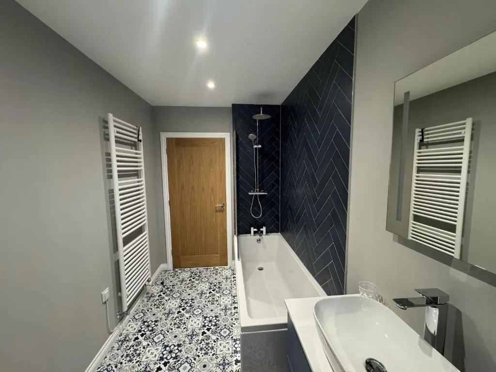 a bathroom with a tub and a sink and a bath tub at Sunny Ridge in Fort Augustus