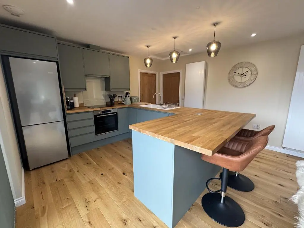 a kitchen with a wooden counter top in a room at Sunny Ridge in Fort Augustus