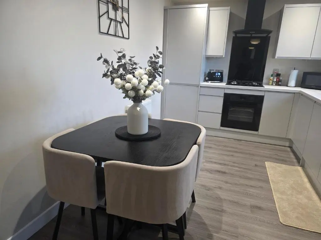 a vase of flowers on a table in a kitchen at Riverside View in Inverness
