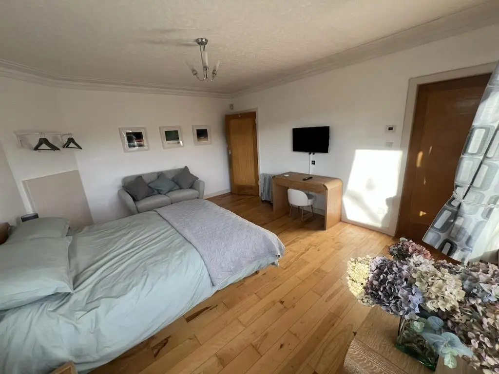 a bedroom with a bed and a television in it at Cluny Corner in Inverness