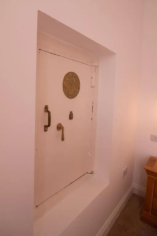 a white door with a plaque on a wall at Calder House, Fochabers in Fochabers