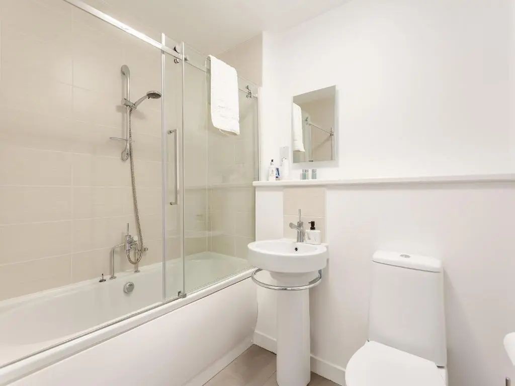 a bathroom with a shower toilet and a sink at Inverness Highland Apartment in Inverness