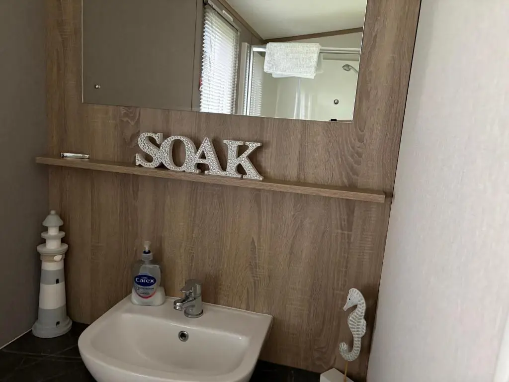 a bathroom with a sink and a mirror at Sunset villa in Lossiemouth