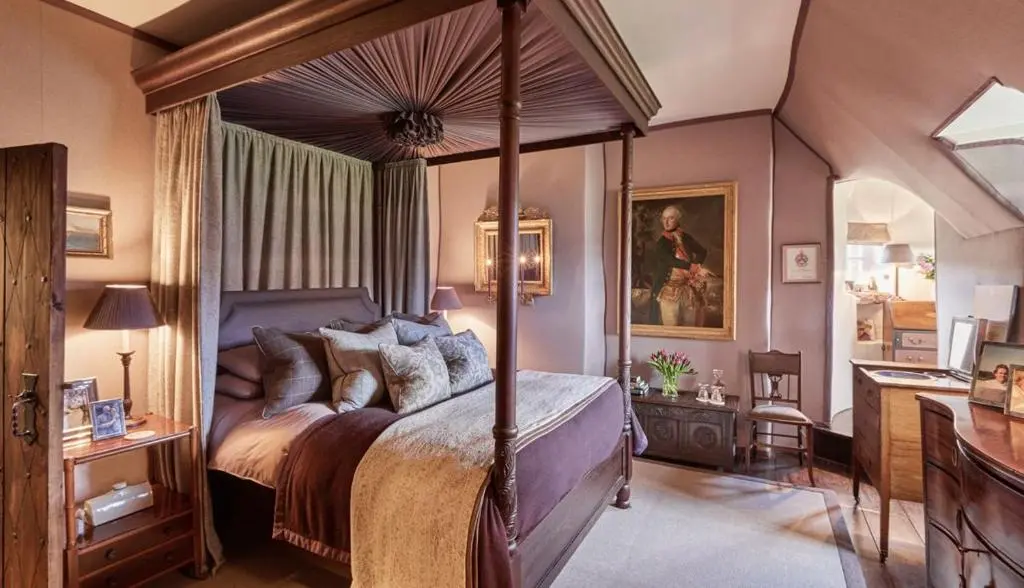a bedroom with a canopy bed and a desk at The Fortalice in Tulchan