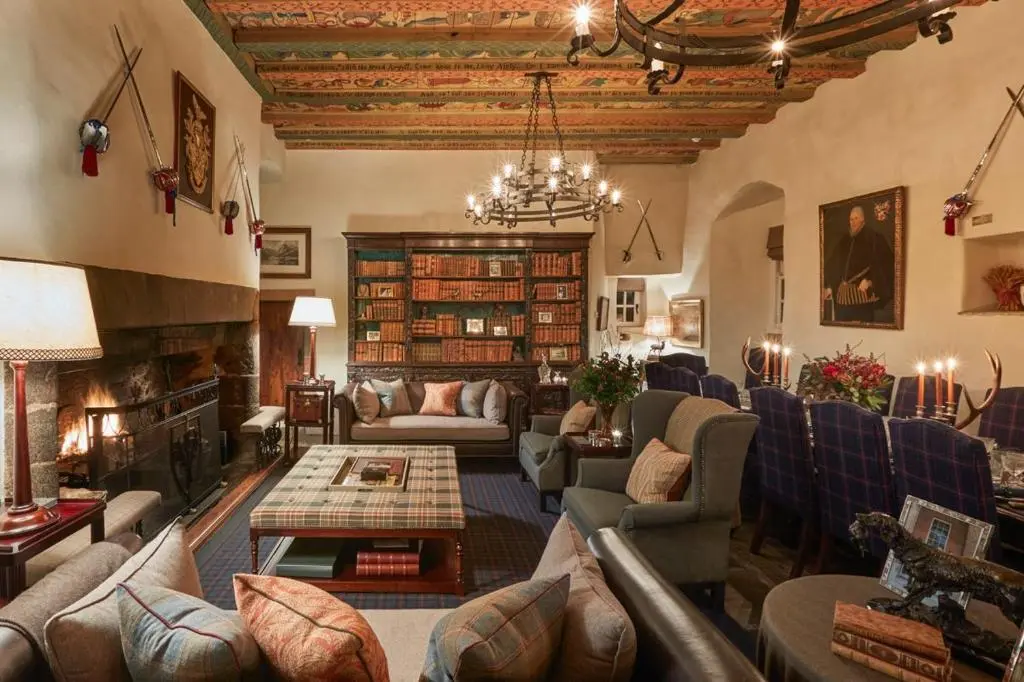 a living room with couches and a fireplace at The Fortalice in Tulchan