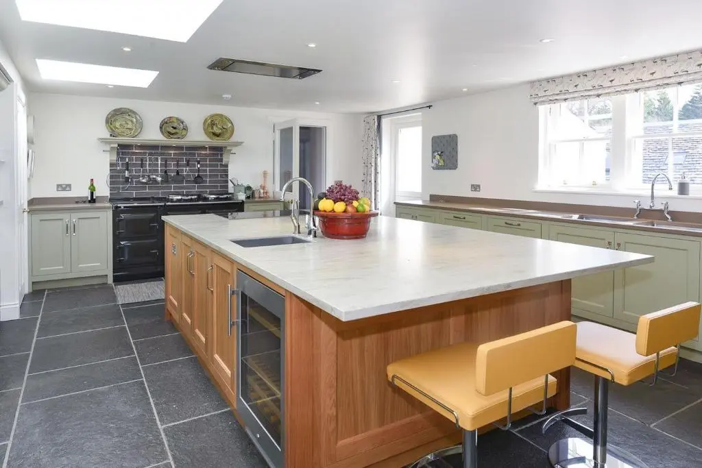 a kitchen with a large island with a counter top at Spey Valley House in Ruthven