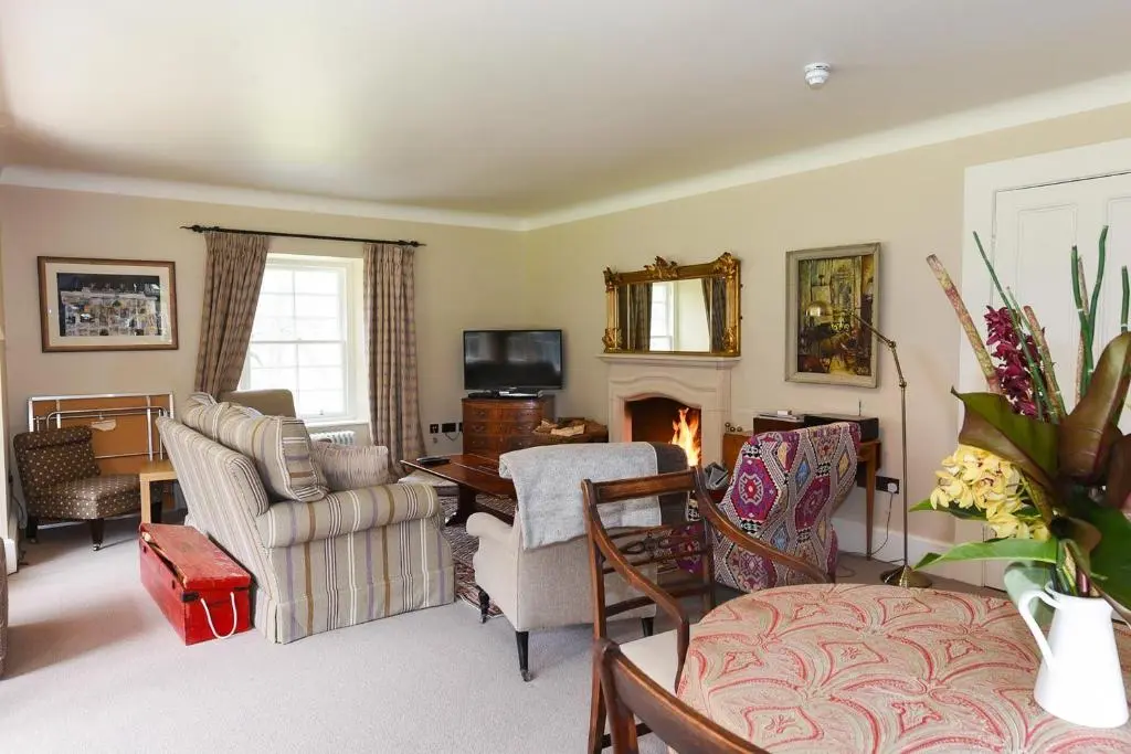 a living room filled with furniture and a fireplace at Spey Valley House in Ruthven