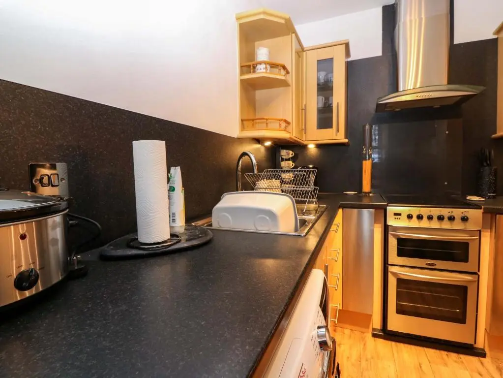 a kitchen with a sink and a counter top at Rose Cottage in Nairn