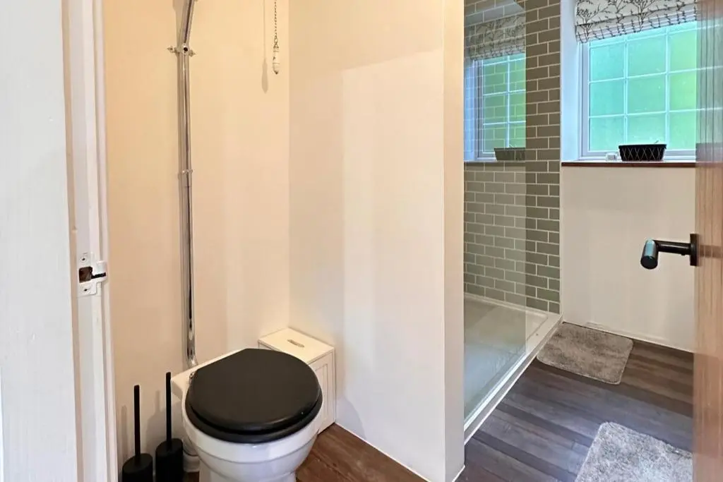 a bathroom with a black toilet and a shower at Pets - Garden - Parking - Sleeps 2 - Hiking in Banchory