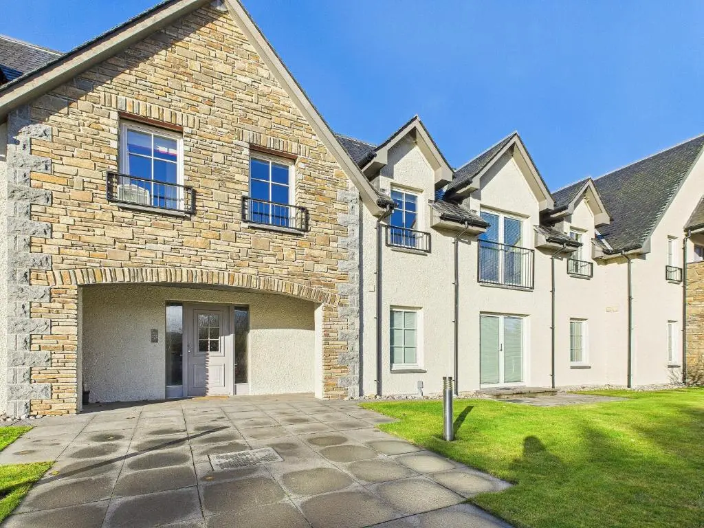 a brick house with a driveway in front of it at The Steadings Aviemore Premium Highland Apartment Near Cairngorms & Town Centre in Aviemore