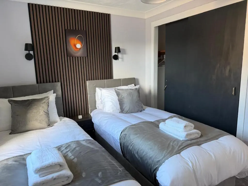 two beds sitting next to each other in a room at Nessy5 Apartment in Inverness