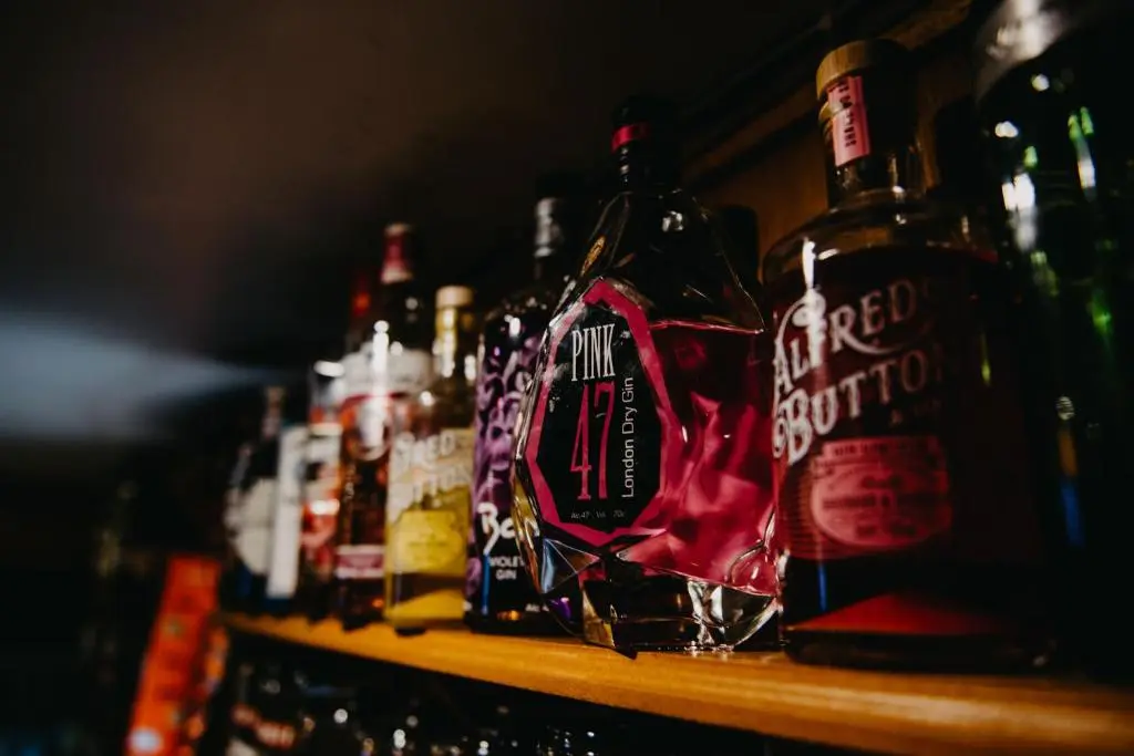 a row of bottles of alcohol sitting on a shelf at Seafield Arms Hotel in Whitehills