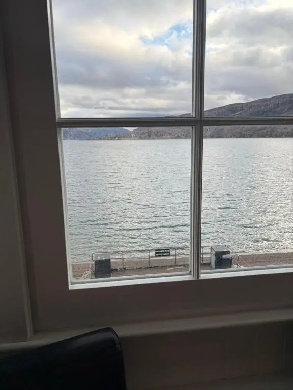 a window with a view of a body of water at Waterside House B&B in Ullapool