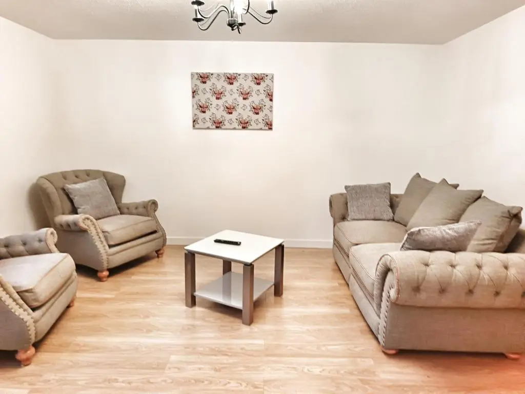 a living room with two couches and a table at 2 Bed, Banchory in Banchory