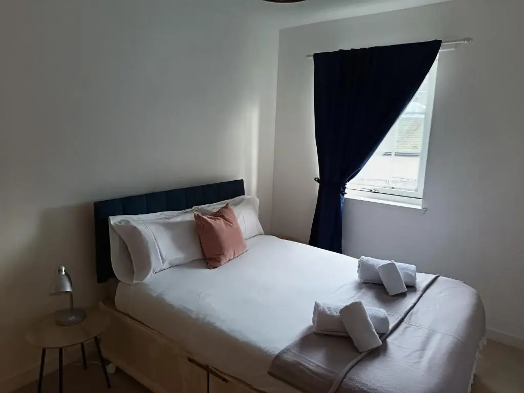a small bedroom with a bed with a window at 2 Bed, Banchory in Banchory